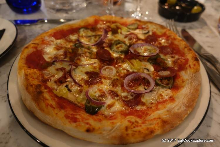 Pizza with pepperoni, mushrooms and chillies